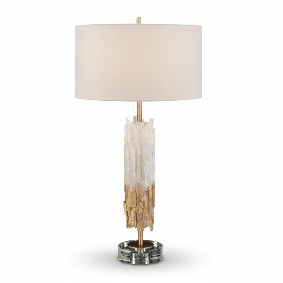 Table lamp with crystal base and beige shade on a black background