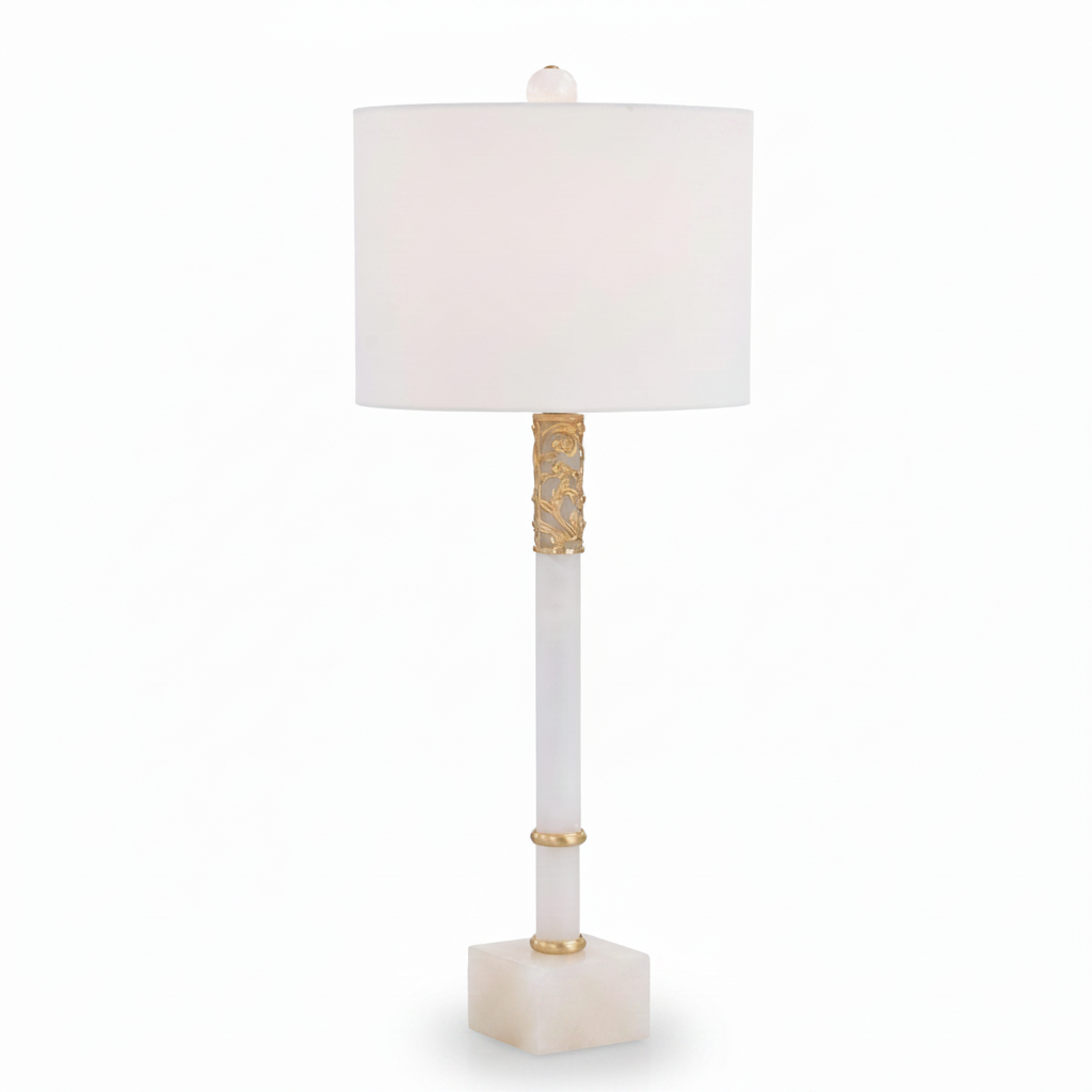 Decorative table lamp with a white shade and gold accents on a white background