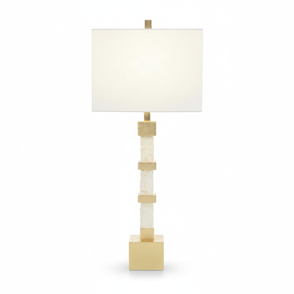 Table lamp with a white shade and gold accents on a white background