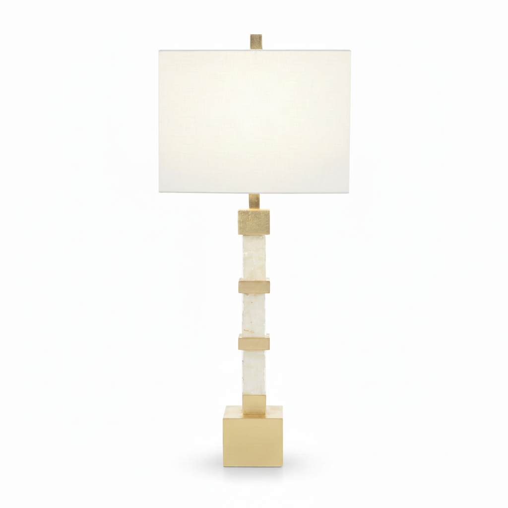 Table lamp with a white shade and gold accents on a white background