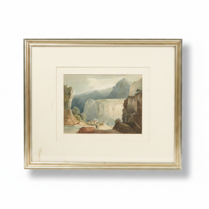 Framed artwork of a mountainous landscape with a river and buildings.