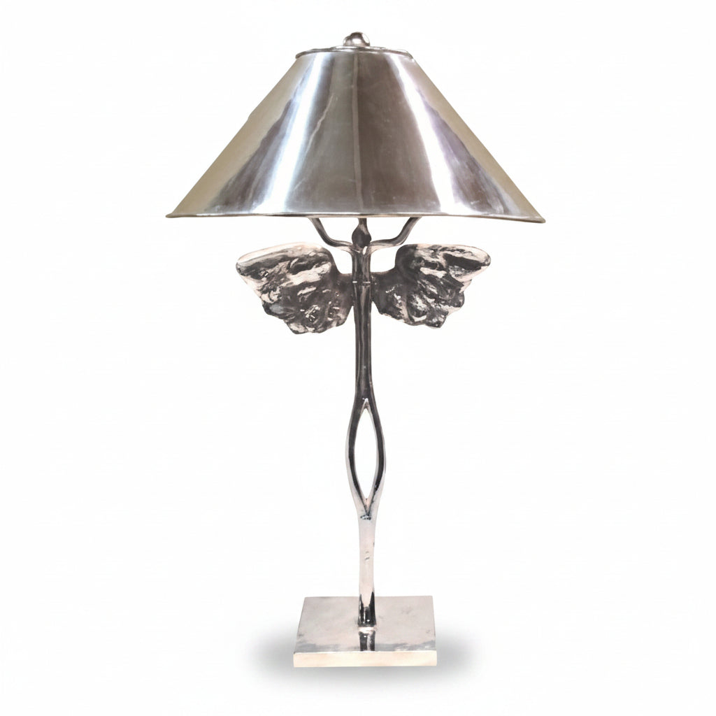 Silver table lamp with decorative base on a white background