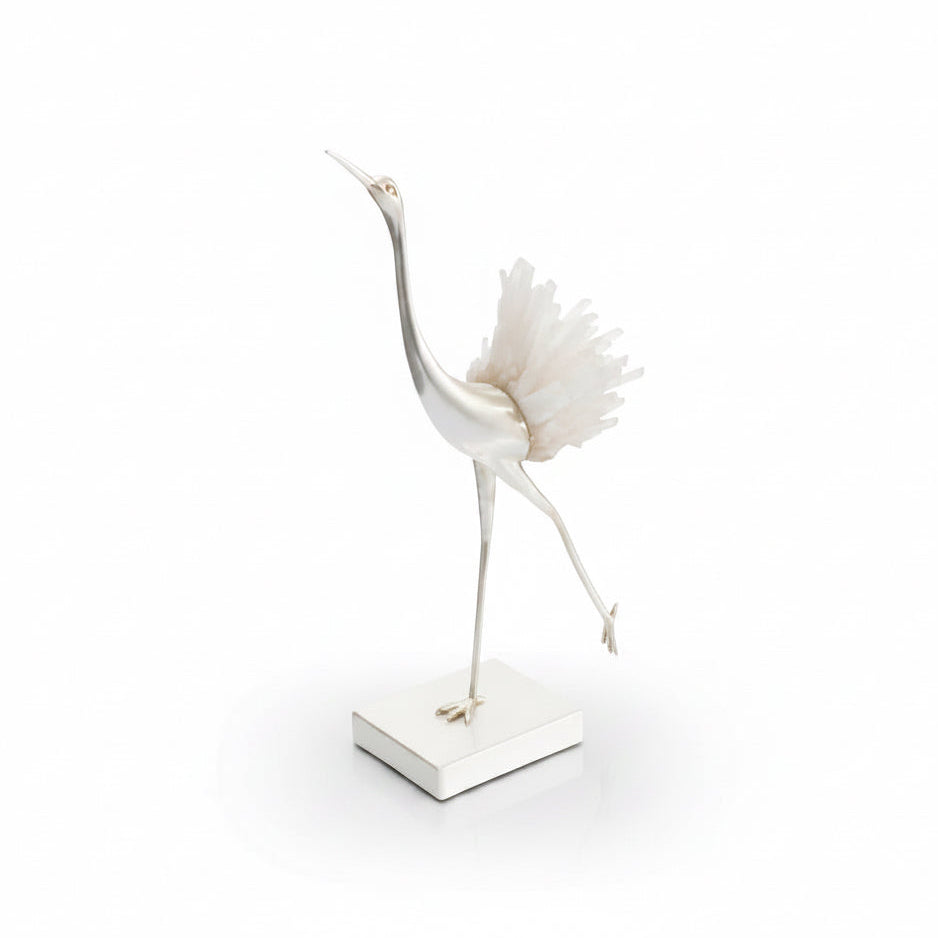 Decorative sculpture of a crane with a shell on a white background