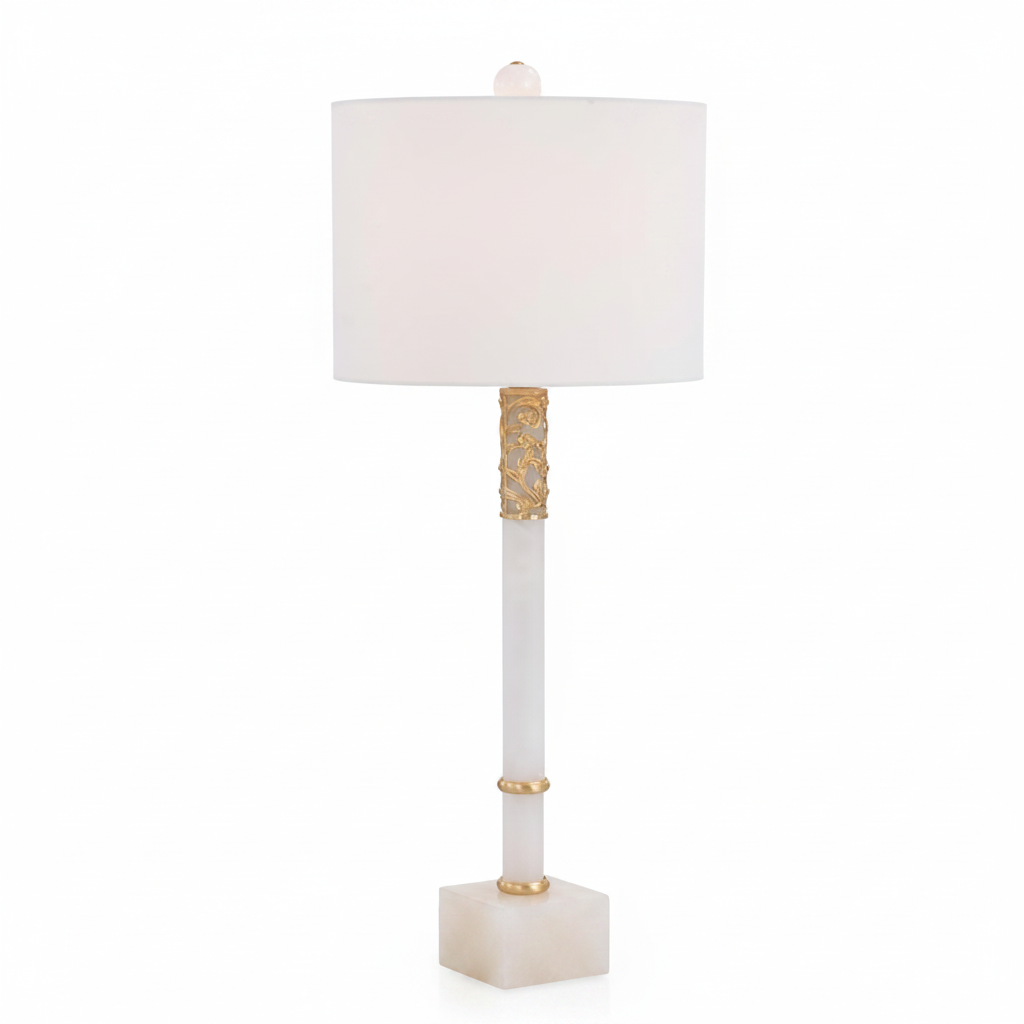 Decorative table lamp with a white shade and gold accents on a white background