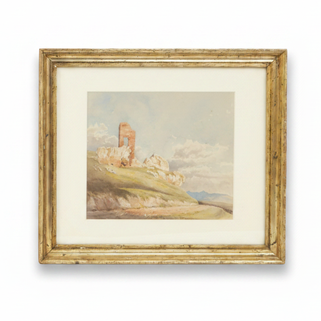 Framed artwork of a landscape with ruins on a hillside.
